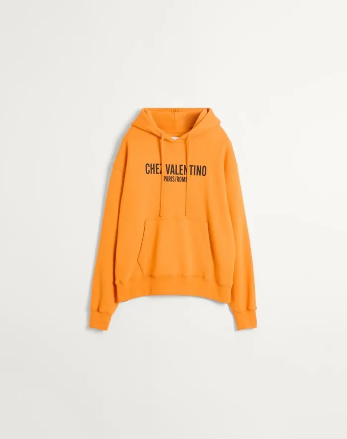 Valentino Tshirts And Sweatshirts Man Cotton Hooded Sweatshirt With Chez Valentino Print For Man In Orange Orange Valentino Tshirts And Sweatshirts Man Cotton Hooded Sweatshirt With Chez Valentino Print For Man In Orange Orange